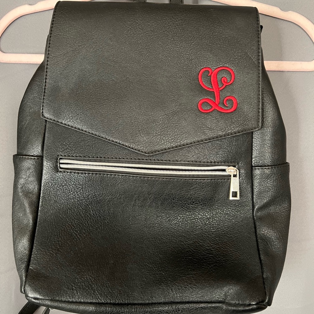 Initials, inc. Black backpack with Red Letter L monogram.